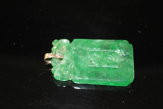 A simulated jade rectangular pendant with yellow metal mount (tests at 9ct gold), carved with scrolling motifs, 54mm,